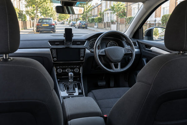 Original front seats and dashboard of a parked right-hand-drive private hire car.